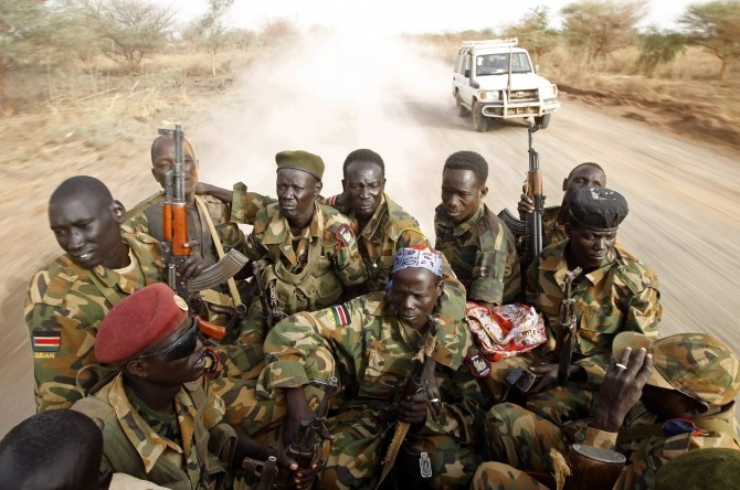 South Sudan's army, or the SPLA, soldiers drive in a truck on the frontline in Panakuach, Unity state