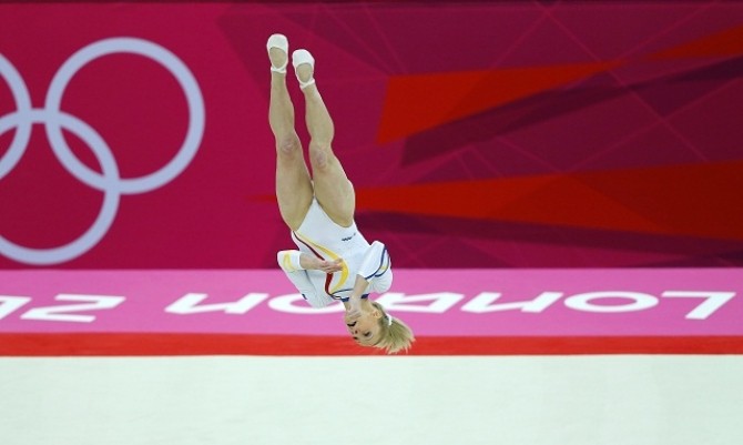 Sandra Raluca Izbasa of Romania competes in the floor exercise during the women's gymnastics qualification in London