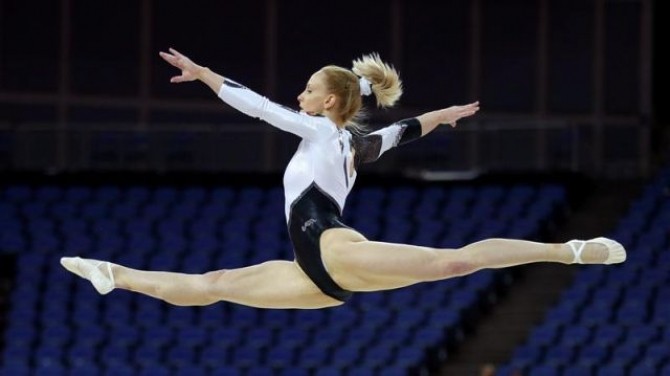 Sandra Raluca Izbasa of Romania practices on the floor during a gymnastics training session at the North Greenwich Arena before the start of the London 2012 Olympic Games