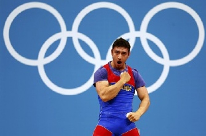 Romania's Razvan Constantin Martin reacts after successful lift on the men's 69Kg Group A weightlifting competition at the ExCel venue at the  London 2012 Olympic Games