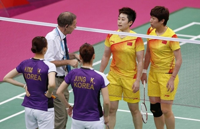File photo of an official speaking to players from China and South Korea during their women's doubles badminton match during the London 2012 Olympic Games at the Wembley Arena