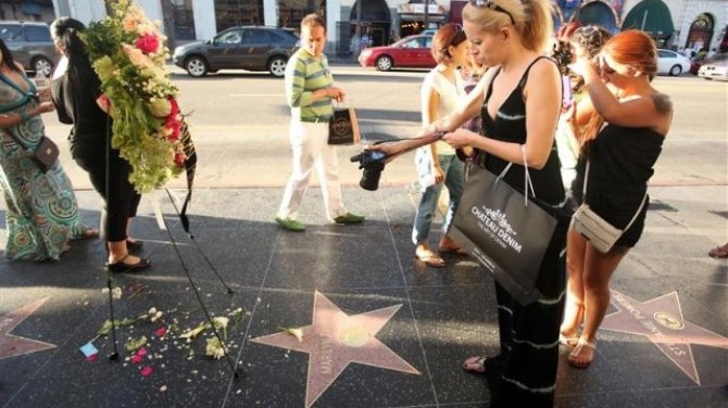 Fans take pictures of a memorial on Marilyn Monroe's Hollywood Walk of Fame Star on the 50th Anniversary of her death in Hollywood