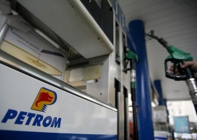 Man lifts pump at Petrom gas station in Bucharest