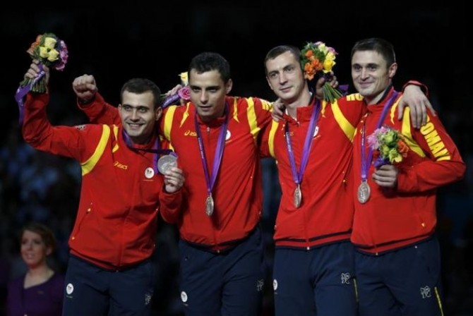 Romania's fencing team pose with their silver medals during the men's sabre team fencing competition victory ceremony at the London 2012 Olympic Games