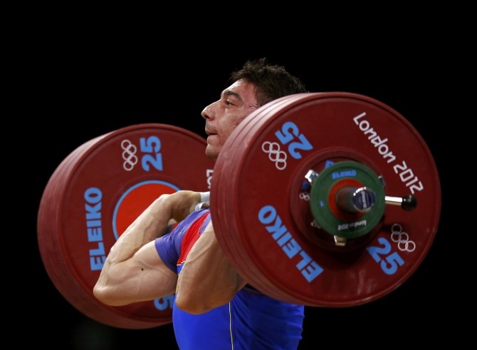 Romania's Razvan Constantin Martin competes on the men's 69Kg Group A weightlifting competition at the ExCel venue at the  London 2012 Olympic Games