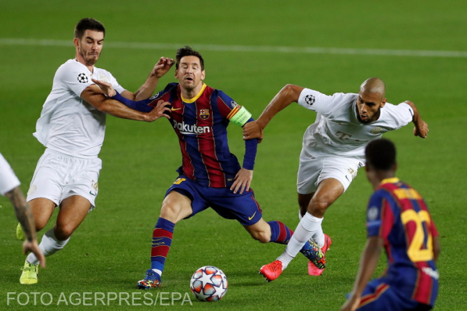 Lionel Messi în acțiune împotriva mijlocașilor lui Ferencvaros, Aissa Laidouni și Ihor Kharatin, în timpul partidei  dintre FC Barcelona și Ferencvaros, de pe Camp Nou