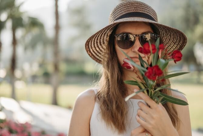 Photo by Pavel Danilyuk: https://www.pexels.com/photo/close-up-shot-of-a-woman-wearing-sunglasses-holding-red-flowers-9119613/